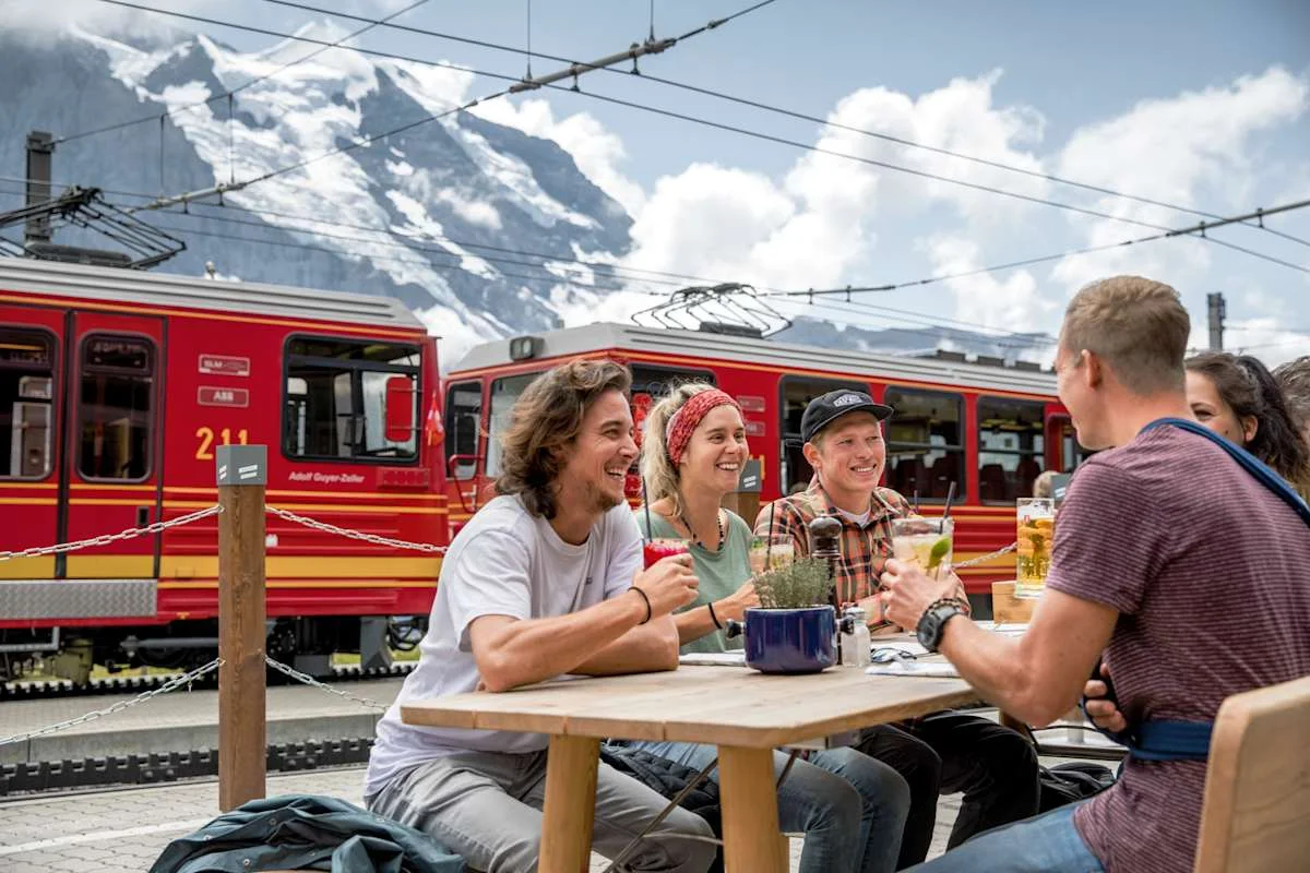 Four people on the terrace of Bergrestaurant Kleine Scheidegg