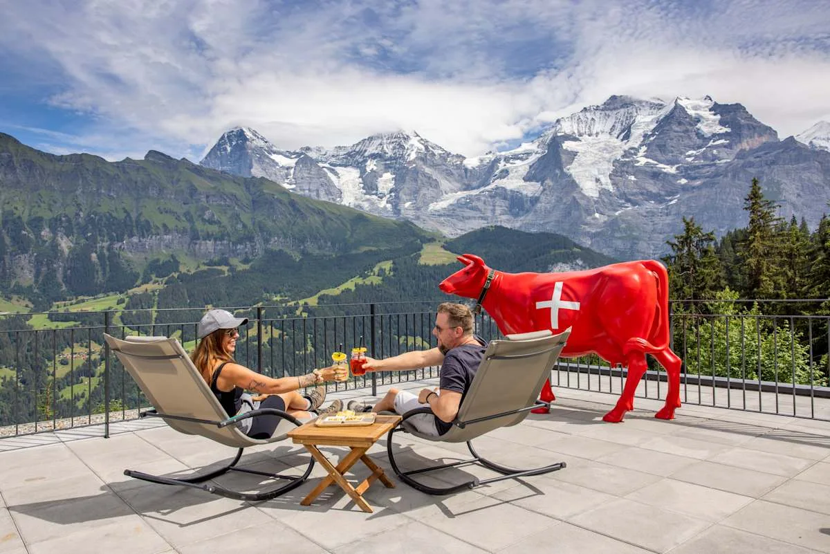 Two people on deckchairs on the terrace of Bistro Grütschalp