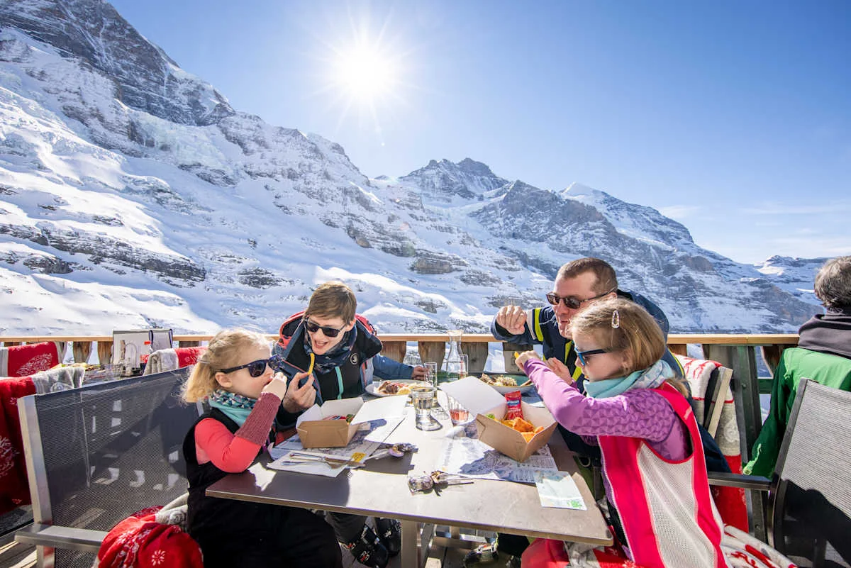 Family eating on the terrace of Restaurant Eigergletscher