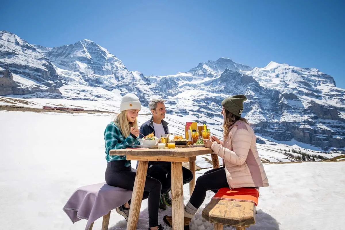 Three people eating at Bergrestaurant Kleine Scheidegg