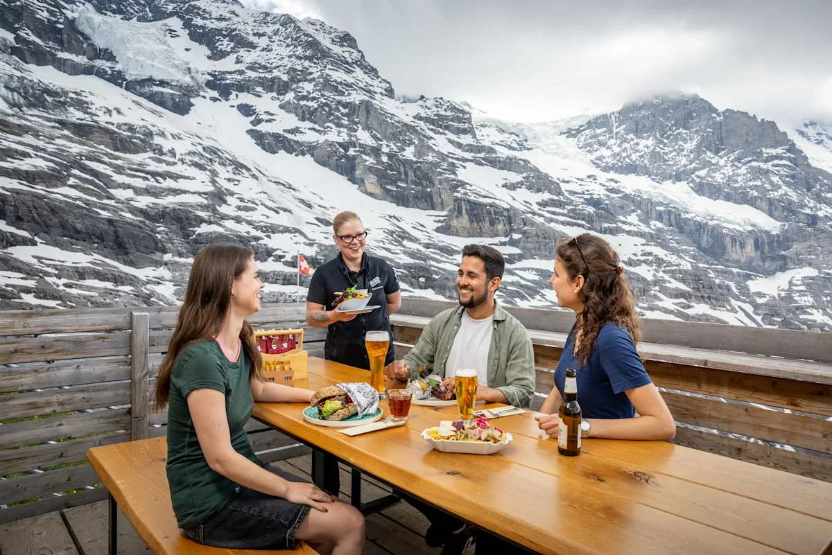 The Wall Bar terrace with three people being served