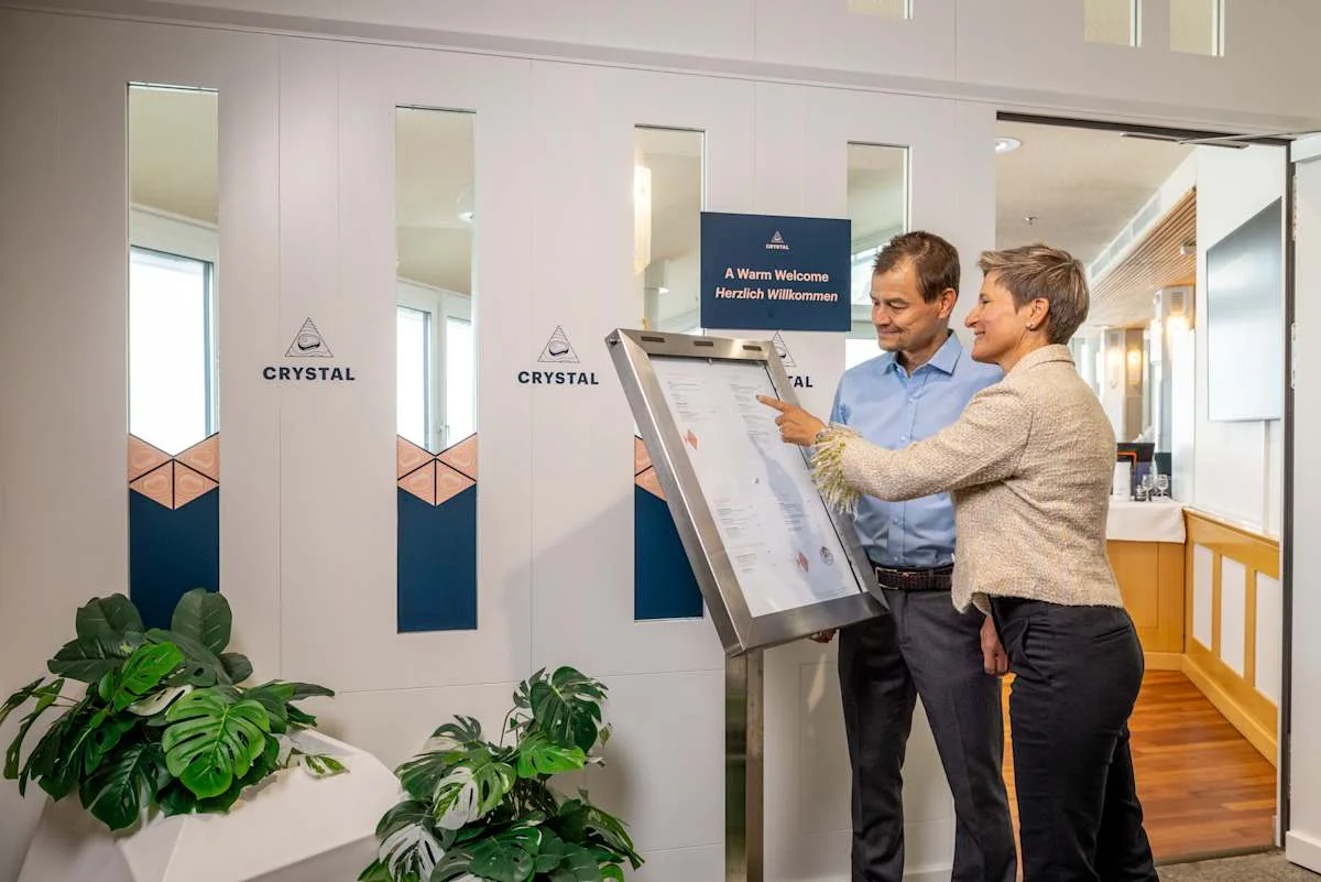 People looking at the menu at the entrance of Restaurant Crystal